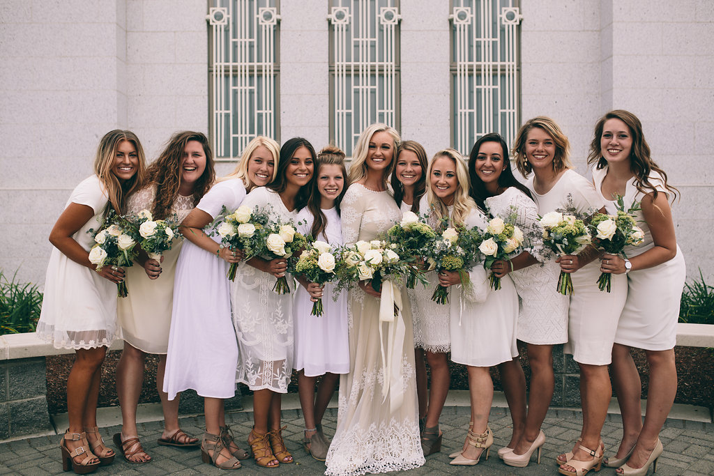 Wedding party of bride and bridesmaids holding their designed diy flowers