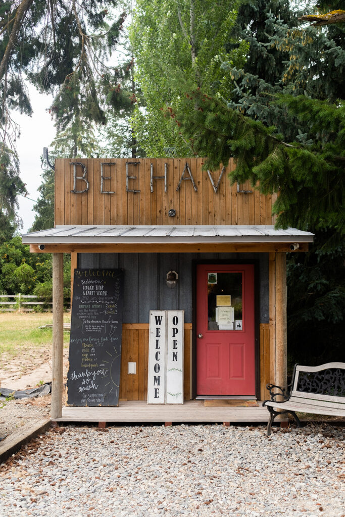 A cute farm stand that is western style and looks like an old western saloon style.